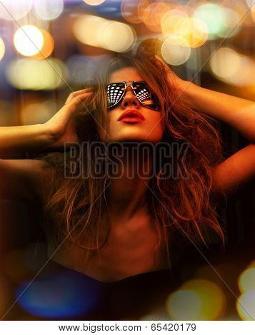 dark color toned picture of fashionable woman in nightclub