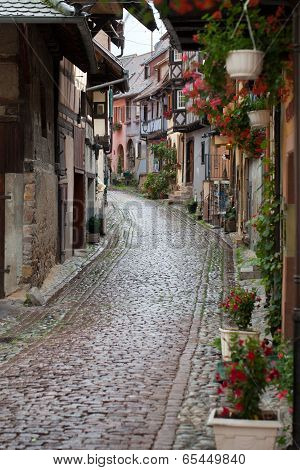 Street with half-timbered medieval houses in Eguisheim village along the famous wine route in Alsace