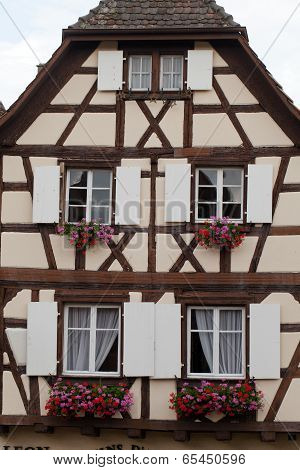 Street with half-timbered medieval houses in Eguisheim village along the famous wine route in Alsace
