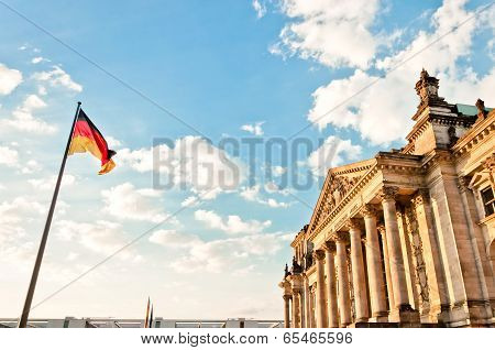 German Parliament with national flag in Berlin, Germany
