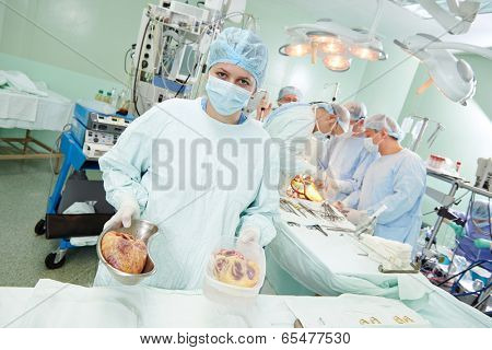 Team of surgeon perform heart transplantation operation on a patient at cardiac surgery clinic