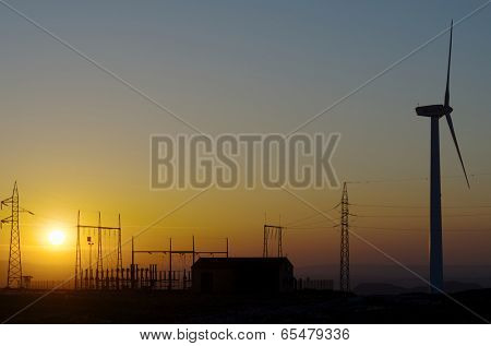 silhouette of a alectrical substation and windmill, La Muela, Zaragoza, Aragon, Spain