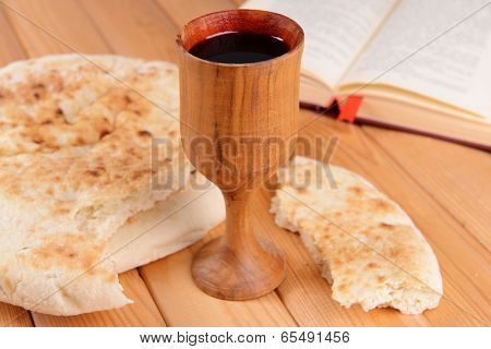 Cup of wine and bread on table close-up