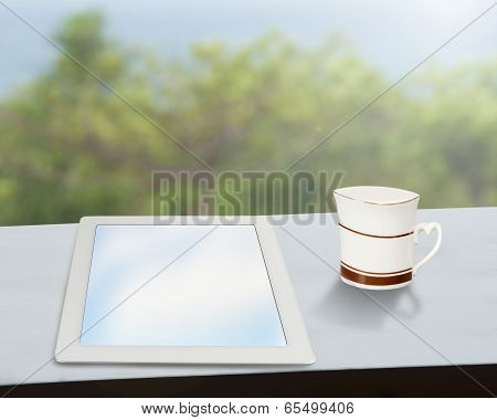 Tablet With Coffee Mug On Window Side Table