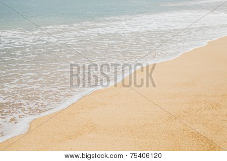 Sea with foam and sand closeup