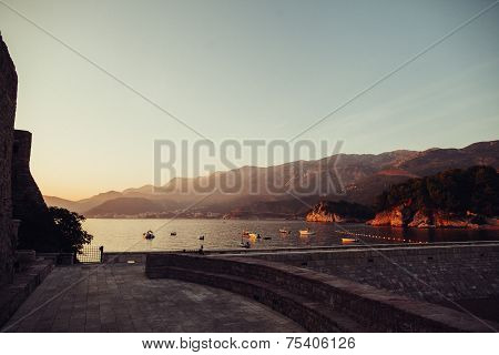 Sunset bay with boats and mountains vintage