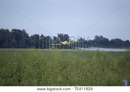 Yellow Crop Dusting Airplane Spraying Farm Field