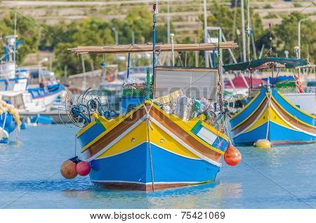 Traditional Luzzu Boat At Marsaxlokk Harbor In Malta.