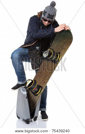 Man trying to put snowboard into suitcase