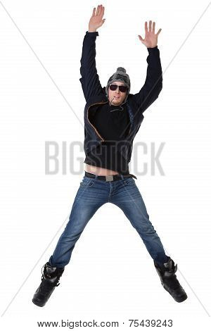 Young joyful man in winter wear jumping