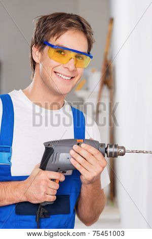 Smiling repairman with drill