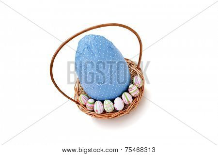 Easter eggs in a basket - high angle view on white background