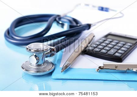 Stethoscope on light blue background