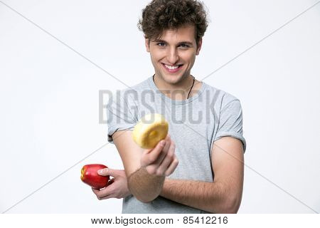 Happyman holding apple and donut over gray background
