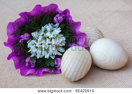 Snowdrop flowers and wooden eggs