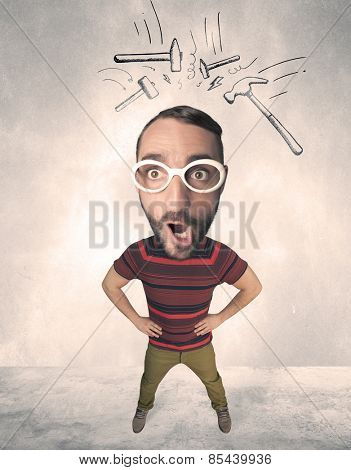 Funny person with big head and drawn punching hammers over it 