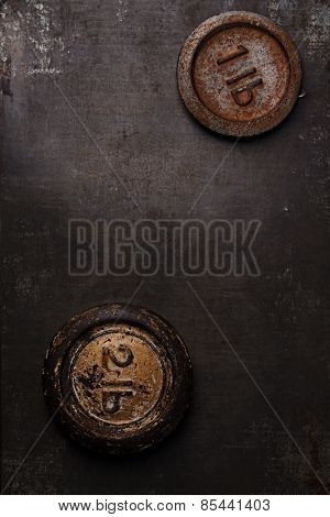 1lb pound vintage iron weight on metal backdrop