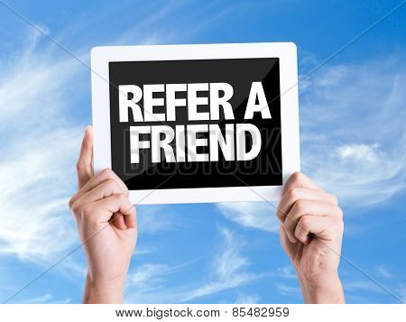 Tablet pc with text Refer a Friend with sky background