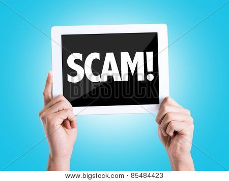 Tablet pc with text Scam! with blue background