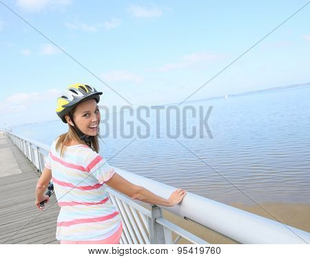 Portrait of young woman riding bike on a pontoon