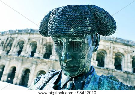 NIMES, FRANCE - MAY 12: Statue of bullfighter Christian Montcouquiol, Nimeno II, in front of the Arena of Nimes on May 12, 2015 in Nimes, France. This Roman amphitheater serves as bullring since 1863