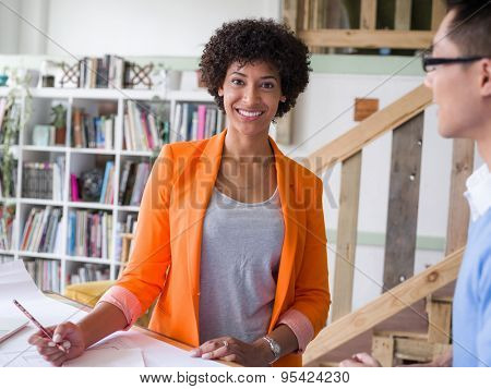 Two desingers working on a project together in office