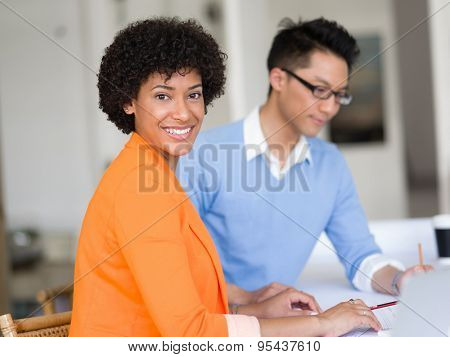 Two desingers working on a project together in office