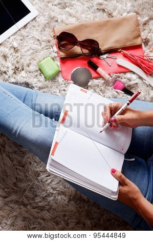 Woman Writing Into Her Desk Diary