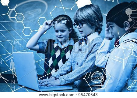 Science graphic against school kids using laptop in classroom