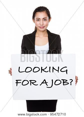 Beautiful businesswoman showing a board showing with looking for a job phrases 