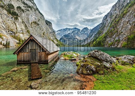 Boat dock hangar on Obersee mountain lake in Alps. Bavaria, Germany