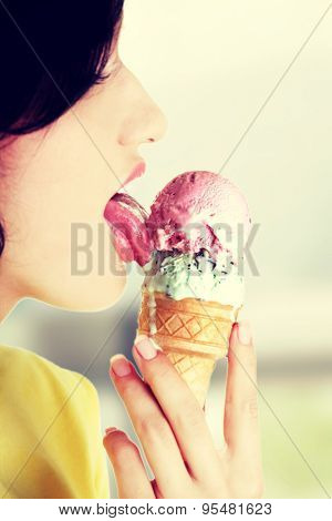 Young woman eating tasty ice cream