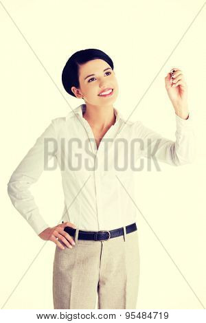 Happy businesswoman drawing on a glassboard