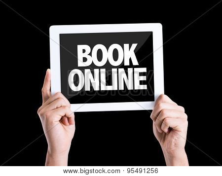 Tablet pc with text Book Online isolated on black background