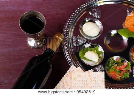 Matzo for Passover with Seder meal with wine on plate on table close up