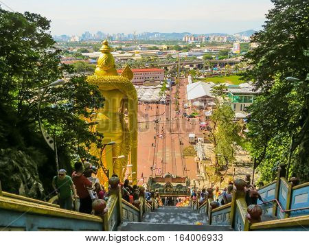 KUALA LUMPUR, MALAYSIA - JANUARY 13, 2014: Pilgrims and visitors on a huge ladder to Batu Caves. Kuala Lumpur, Malaysia