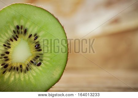 Ripe fresh kiwi isolated on wood desk. Food ingredient. Nature background