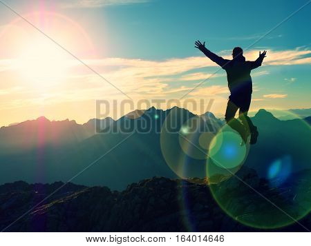 Lens Flare Effect. Bow Light Circles. Crazy Hiker Jumping At Peak Of Mountain.
