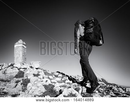 Adult Tourist With Backpack Walk On Mountain Peak. Last Step To Summit Stone