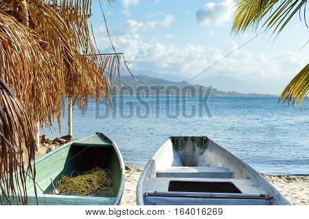 Colorful boats and the beautiful tropical coast of the Caribbean sea by the little town of Omoa in Honduras. Central America