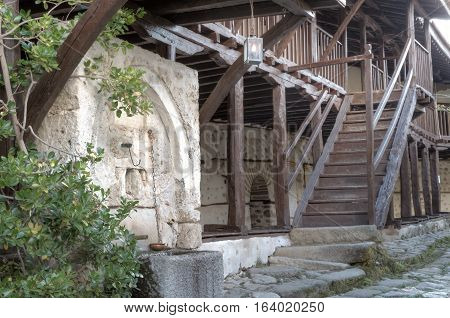 Old vintage stone fountain in rural house backyard
