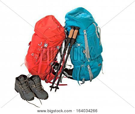 Hiking equipment rucksacks poles and boots. Isolated on white background.