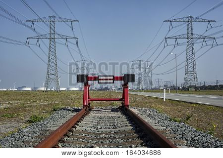 End of the line. A red railway stopper the the end of rusty train track. Port of Rotterdam. The Netherlandds