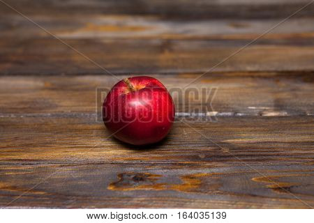 Red apple ripe appl on a wooden background close up