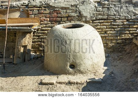 Vintage Uzbek oven tandoor for baking bread Bukhara Uzbekistan.
