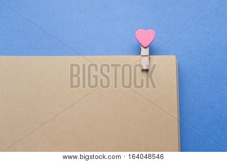 Clothespins with hearts are Notepad. Background is blue paper