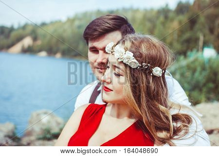 Couple sitting on a bench looking into the camera