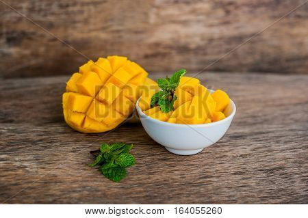 Mango Fruit And Mango Cubes On The Wooden Table.