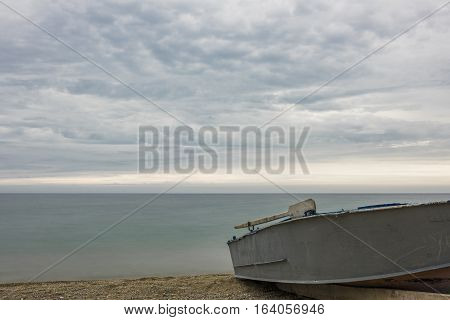 Fishing boat on the shore of lake Baikal is waiting for good weather to go fishing.