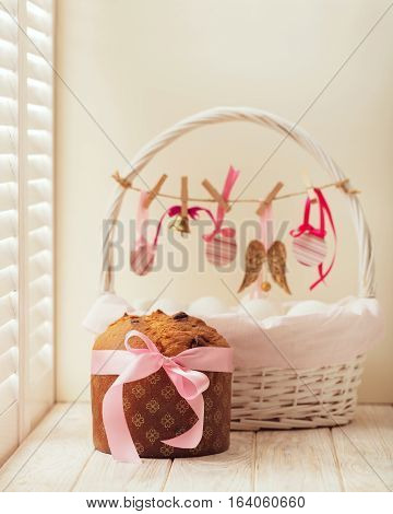 Easter cake and basket with eggs and Easter decor.